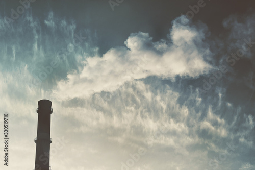 Smoke factory chimney. Heat power center. Smokestack against the dark sky. Smoke from the chimney of a power plant