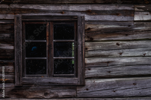 Old antique window in a wooden hut