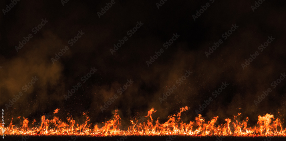 burning dry field in night