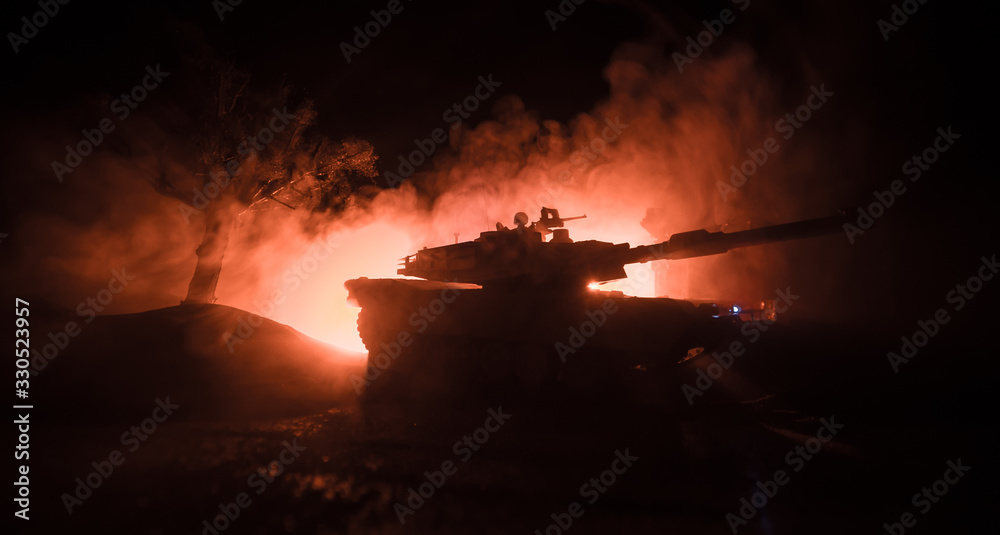 War Concept. Armored vehicle silhouette fighting scene on war foggy sky background at night.