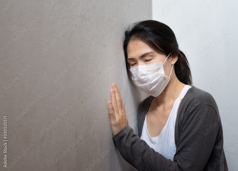 Female Asian young woman wearing surgical mask feeling sick headache and coughing leaning on wall isolated on white background.Wuhan coronavirus (COVID-19) outbreak prevention. Health care concept Female Asian young woman wearing surgical mask feeling sick headache and coughing leaning on wall isolated on white background.Wuhan coronavirus (COVID-19) outbreak prevention. Health care concept