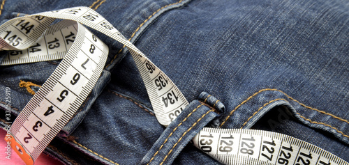 measuring tape on blue jeans