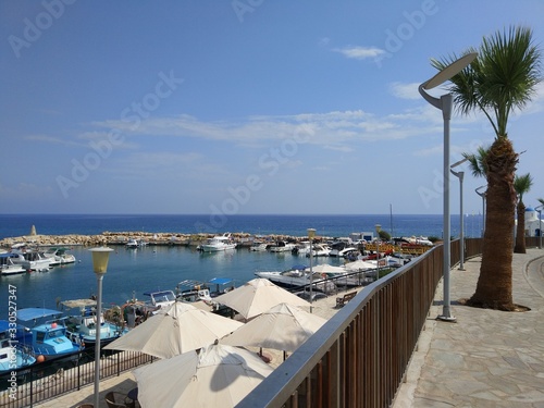 promenade with umbrellas and boat Parking in Cyprus