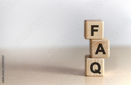FAQ - text on wooden cubes, on wooden background photo