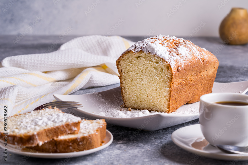 Morning tea concept. Cake and a Cup of tea on a table, pears on blurred bokeh background.