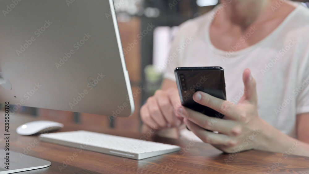 Close Up Shoot of Guy Hands Scrolling Smartphone on Desk