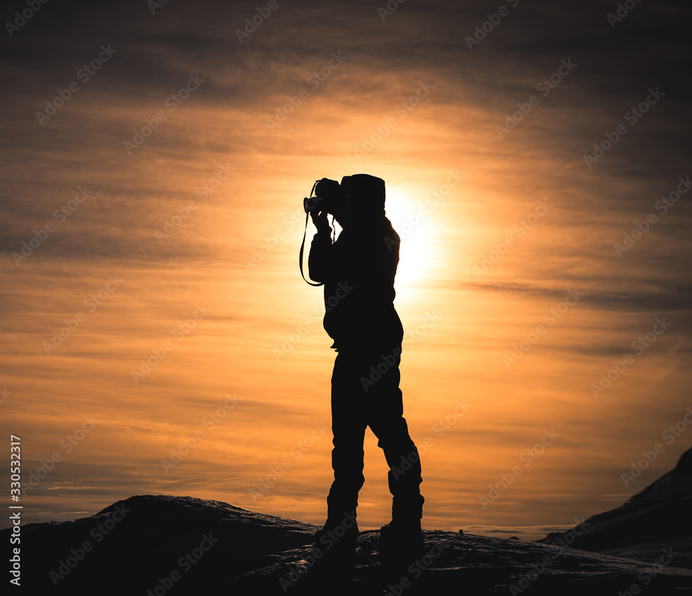 Photographer silhouette doing pictures in Lofoten Norway