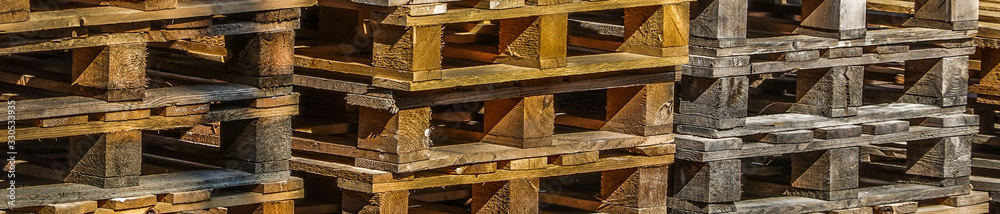 Abstract pick-up of stacked wooden pallets. Long format, panorama for website headline Abstract pick-up of stacked wooden pallets. Long format, panorama for website headline