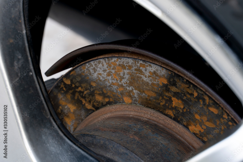 Disc brakes of cars that have rust stains attached.