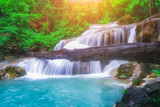 The beautiful Erawan cascade waterfall with turquoise water like heaven and sunlight at the tropical forest ,Kanchanaburi National Park, Thailand