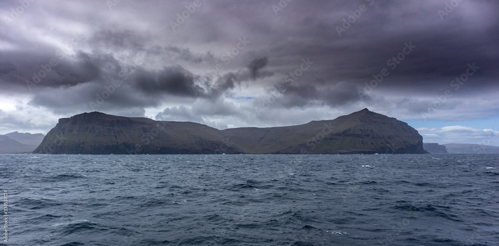 Stóra Dímun island in the Faroe Islands as seen from the ocean 