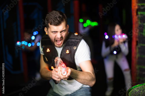 Young man on laser tag arena