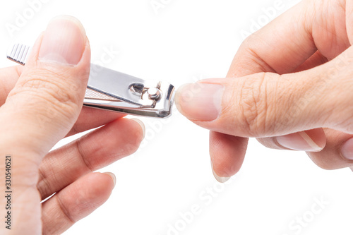 Close up cutting long fingernails and dirty using nail clipper, isolated on white background with clipping path, health care protection and cleanliness concept.