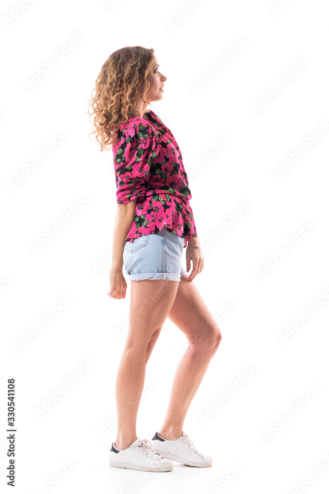 Profile view of happy young trendy woman in summer wear looking up interested. Full body length isolated on white background. Profile view of happy young trendy woman in summer wear looking up interested. Full body length isolated on white background.