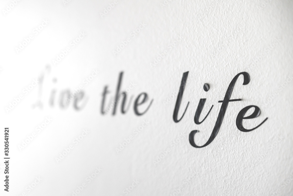 Live the life word phrase on a white wall Live the life word phrase on a white wall