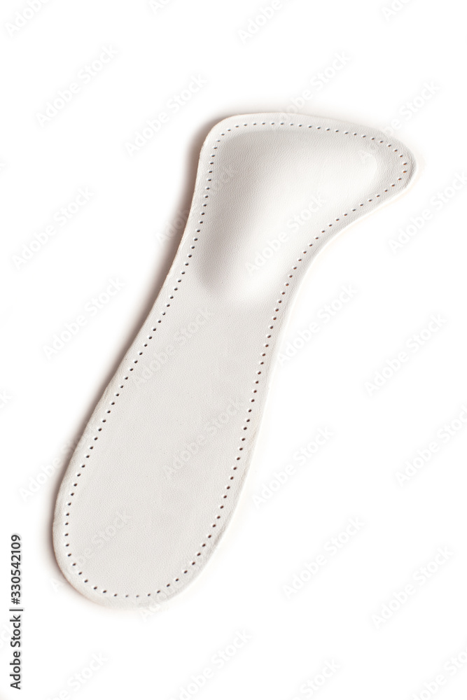 Isolated orthopedic insole on a white background. Treatment and prevention of flat feet and foot diseases. Foot care, comfort for the feet. Wear comfortable shoes. Medical insoles. Isolated orthopedic insole on a white background. Treatment and prevention of flat feet and foot diseases. Foot care, comfort for the feet. Wear comfortable shoes. Medical insoles.