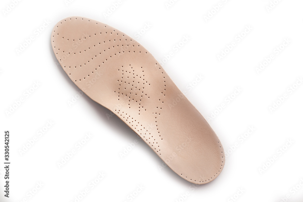 Isolated orthopedic insole on a white background. Treatment and prevention of flat feet and foot diseases. Foot care, comfort for the feet. Wear comfortable shoes. Medical insoles. Isolated orthopedic insole on a white background. Treatment and prevention of flat feet and foot diseases. Foot care, comfort for the feet. Wear comfortable shoes. Medical insoles.