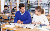 Young people preparing for exam in library