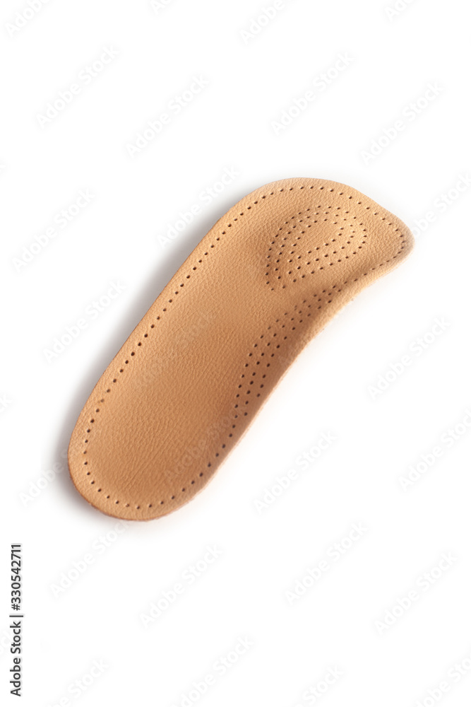 Isolated orthopedic insole on a white background. Treatment and prevention of flat feet and foot diseases. Foot care, comfort for the feet. Wear comfortable shoes. Medical insoles. Isolated orthopedic insole on a white background. Treatment and prevention of flat feet and foot diseases. Foot care, comfort for the feet. Wear comfortable shoes. Medical insoles.