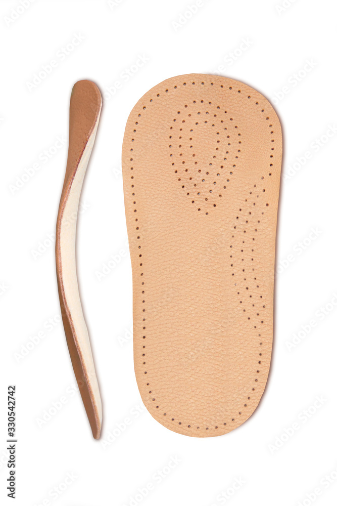 Isolated orthopedic insole on a white background. Treatment and prevention of flat feet and foot diseases. Foot care, comfort for the feet. Wear comfortable shoes. Medical insoles.