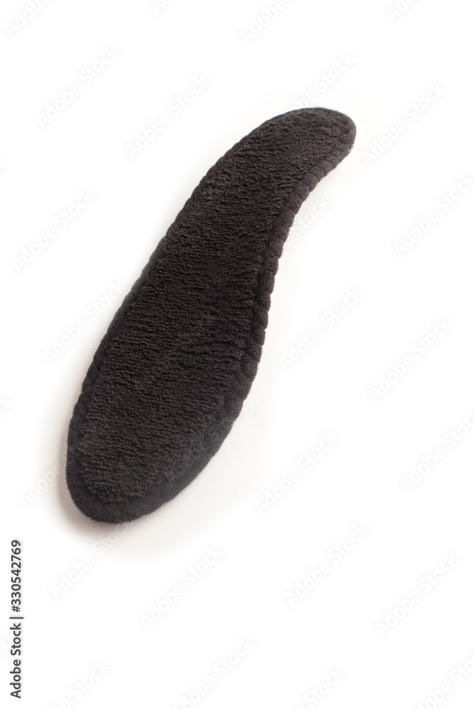 Isolated orthopedic insole on a white background. Treatment and prevention of flat feet and foot diseases. Foot care, comfort for the feet. Wear comfortable shoes. Medical insoles. Isolated orthopedic insole on a white background. Treatment and prevention of flat feet and foot diseases. Foot care, comfort for the feet. Wear comfortable shoes. Medical insoles.