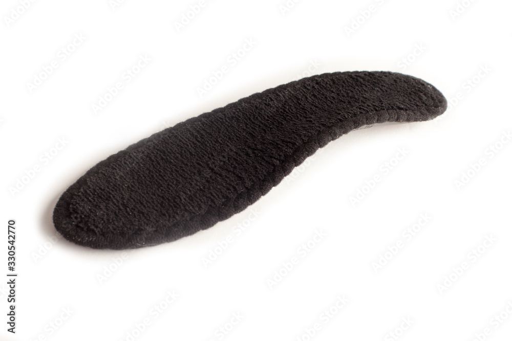 Isolated orthopedic insole on a white background. Treatment and prevention of flat feet and foot diseases. Foot care, comfort for the feet. Wear comfortable shoes. Medical insoles. Isolated orthopedic insole on a white background. Treatment and prevention of flat feet and foot diseases. Foot care, comfort for the feet. Wear comfortable shoes. Medical insoles.