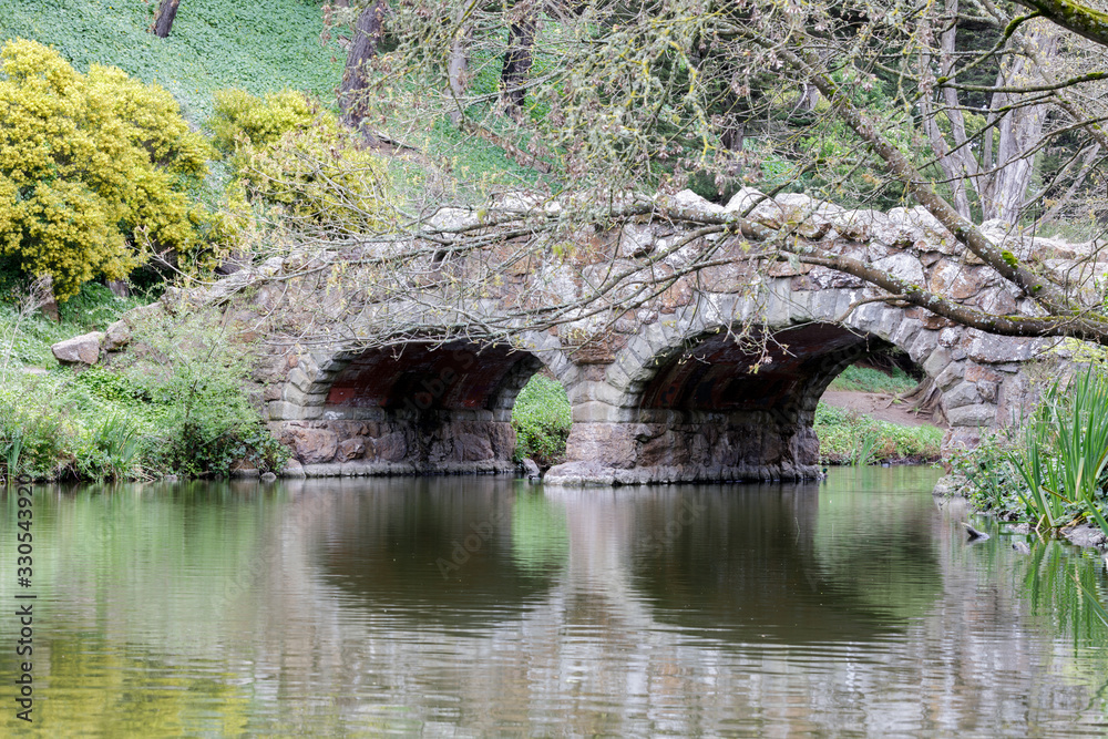 Stone arch bridge over Stow Lake. Golden Gate Park, San Francisco, California, USA.