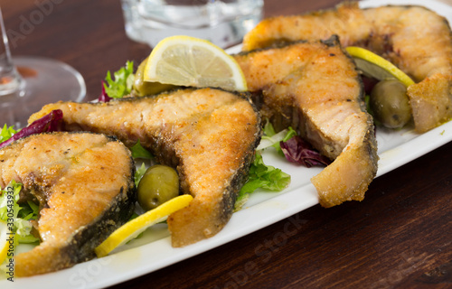 Slices of fried in flour sturgeon