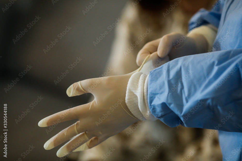 Details with the hands of a medic using surgical gloves
