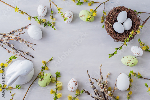 Photography Flat lay easter composition with a willow branch and eggs on a gray background
