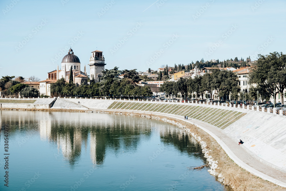 Panoramic of Verona, Italy, with the impressive monument of Porta Trento reflected in the river Panoramic of Verona, Italy, with the impressive monument of Porta Trento reflected in the river