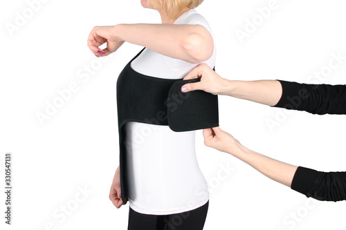 Shoulder Joint Brace. Bandage on the shoulder joint (scarf) with additional fixation. Deso's Handwrap. Supports & Immobilizers. Orthopedic medical Braces. Shoulder injury. photo