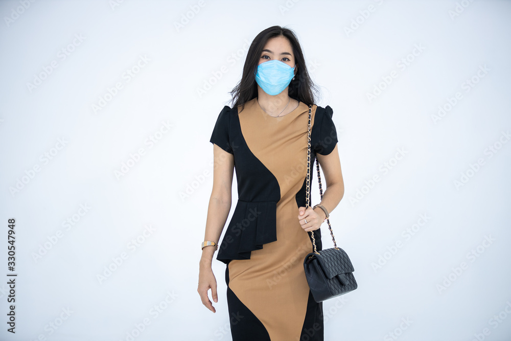 Woman wearing a hygiene protective mask to protect COVID19 virus and pm2.5 pollution while traveling in the crowded place. Woman use face mask to protect corona virus crisis in Asian country. Sickness Woman wearing a hygiene protective mask to protect COVID19 virus and pm2.5 pollution while traveling in the crowded place. Woman use face mask to protect corona virus crisis in Asian country. Sickness