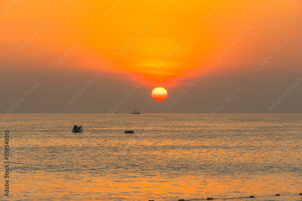 round red sun down to the sea at Patong beach, Phuket,Thailand.