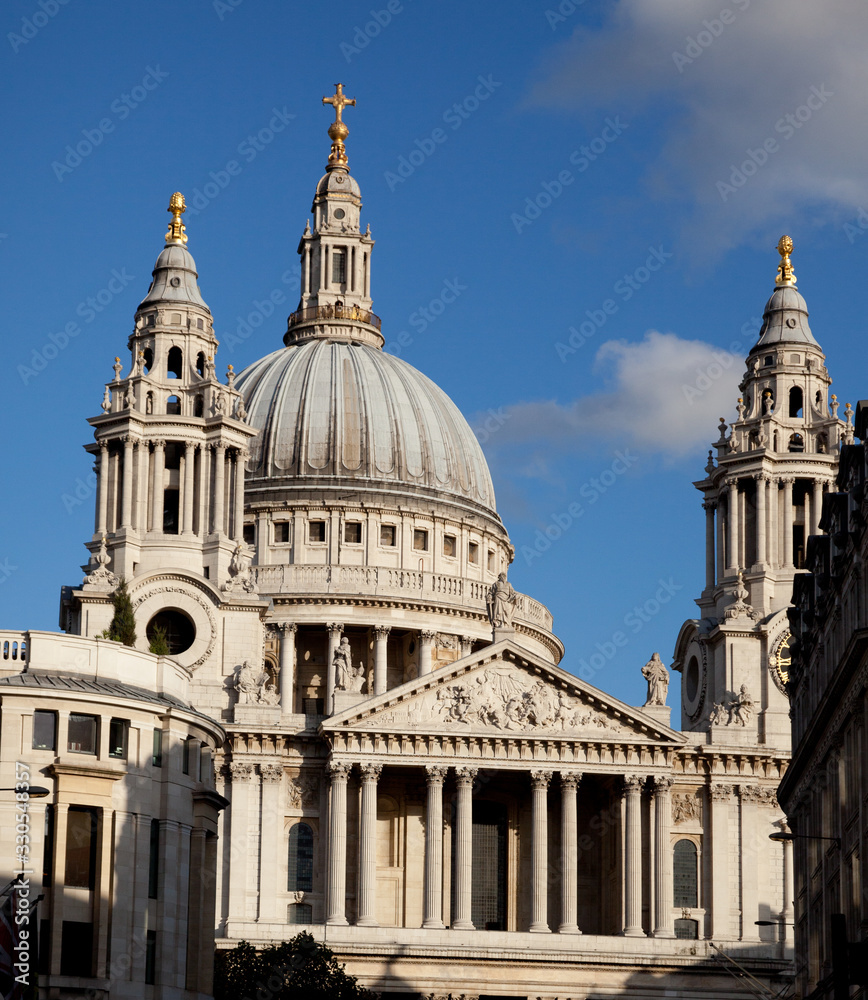 St.Pauls Cathedral in London, England seen in sun with blue sky 