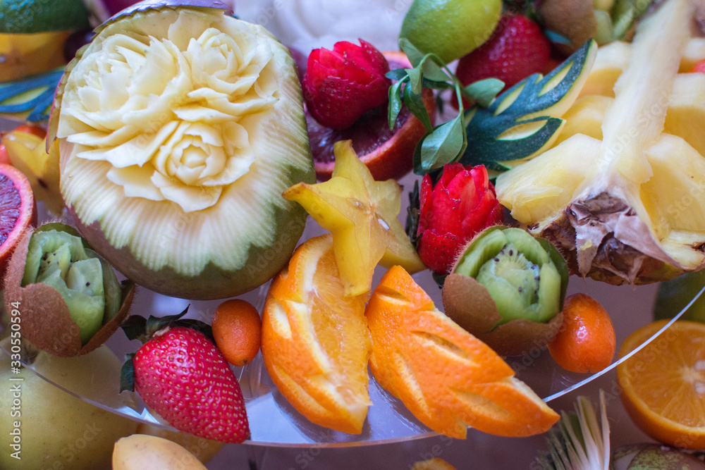 Beautifully sliced fruits on a festive table. Meals for guests during holidays and activities. Carvin fruit.