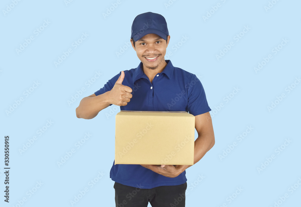 Delivery service concept. Delivery man holding box and showing like on blue background. Delivery service concept. Delivery man holding box and showing like on blue background.