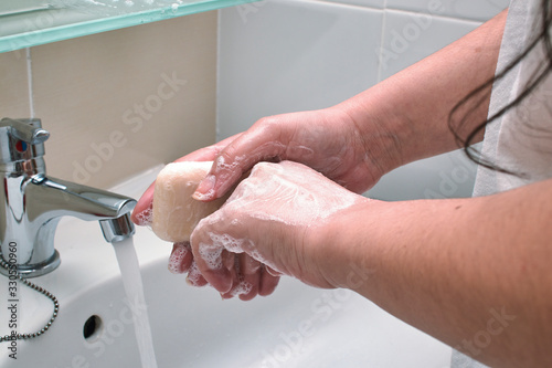 Mujer lavándose las manos y desinfectando de virus y suciedad. photo