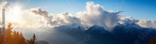 Beautiful Dramatic Canadian Mountain Landscape View during a sunny and cloudy winter sunset. Taken in Squamish, British Columbia, Canada. Nature Background Panorama