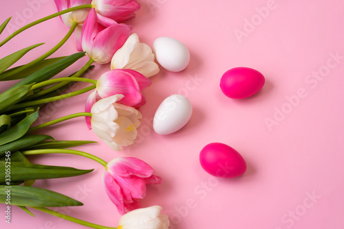 Fototapeta Naklejka Na Ścianę i Meble -  Happy Easter! Bright plastic Easter eggs on a pink background. Decorating the kitchen for Easter on a Sunny day. Greeting card.