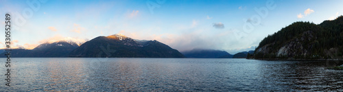 Porteau Cove, Howe Sound, near Squamish and Vancouver, British Columbia, Canada. Beautiful Panoramic Mountain Landscape View of a colorful morning sunrise in winter. Nature Background Panorama