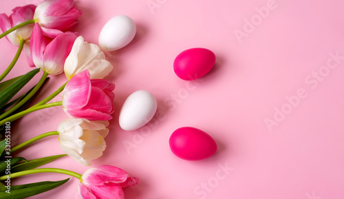 Fototapeta Naklejka Na Ścianę i Meble -  Happy Easter! Bright plastic Easter eggs on a pink background. Decorating the kitchen for Easter on a Sunny day. Greeting card. Copyspase.