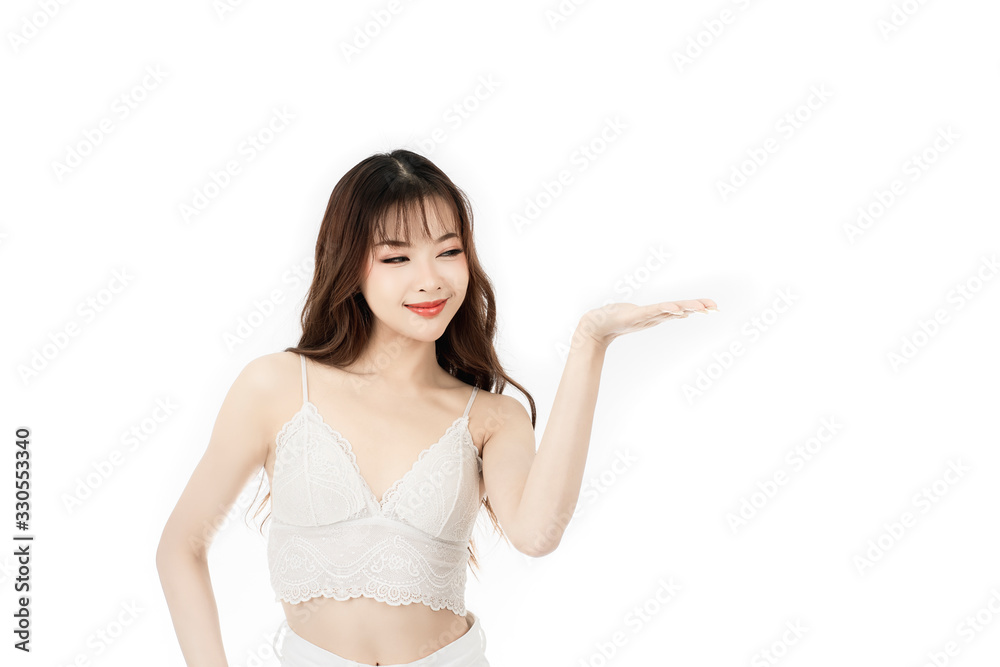 Portrait of attractive asian young woman with beauty skin and face present something on her hand isolated on white background. Healthy skin and face care concept. Portrait of attractive asian young woman with beauty skin and face present something on her hand isolated on white background. Healthy skin and face care concept.