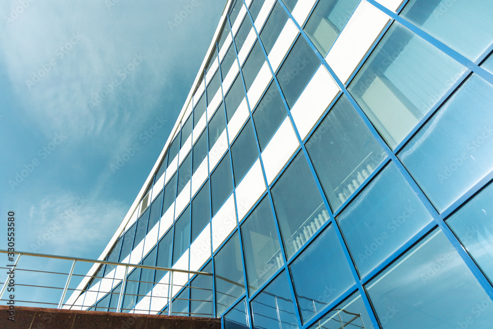 Facade of an office building rising to the sky.