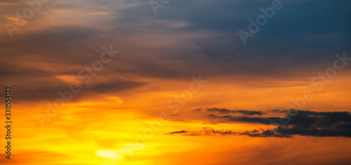 Beautiful colorful bright sunset sky with orange clouds. Nature sky background. 