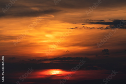 Beautiful colorful bright sunset sky with orange clouds. Nature sky background.  © Inga Av