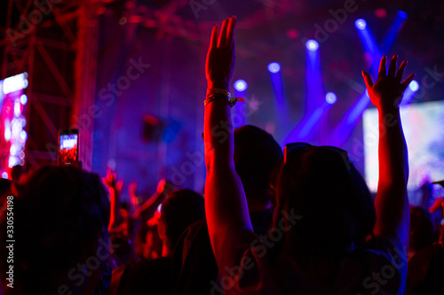 woman raised her hands up at a concert