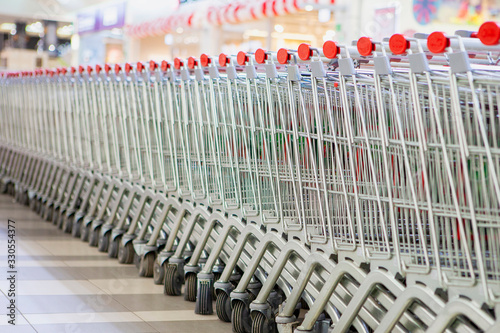 An equal number of shopping carts standing in the store.