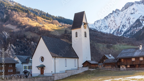 Elm Church during the spectacle of the sun ray through Martinsloch