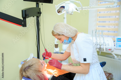 Dentist doctor gives an injection to the patient in the clinic